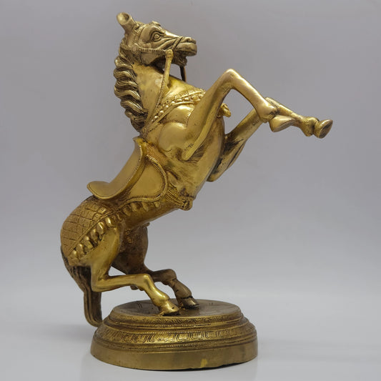 Left side profile view of the thirteen point four inch solid brass rearing horse statue demonstrating the detailed ornate royal saddle blanket textures.