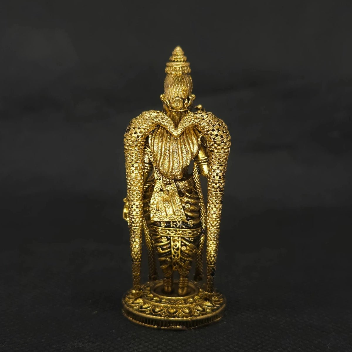 Direct straight back view of the three inch solid brass Madurai Meenakshi amman statue demonstrating the detailed rear surface of her crown and back hair arrangement over the round base.