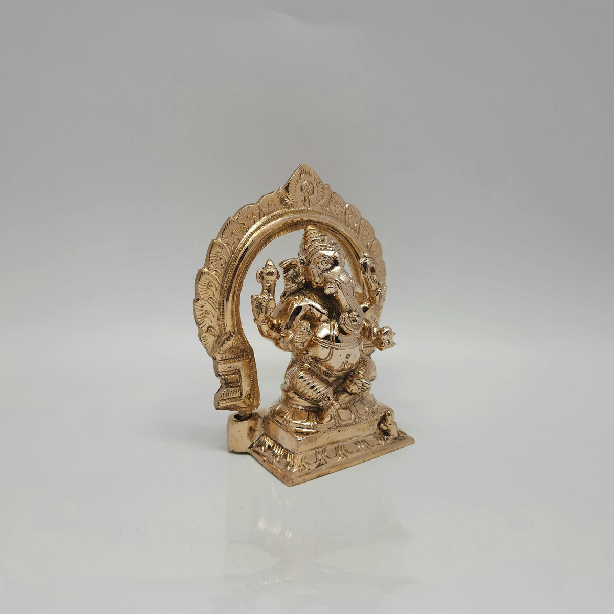 Three-quarter front right perspective of the unlacquered five-metal Panchadhatu Ganesha idol showcasing the sharp crown details