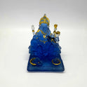 High-angle front view of a 13cm translucent frosted blue glass-look resin Ganesha statue showing the wide rectangular base