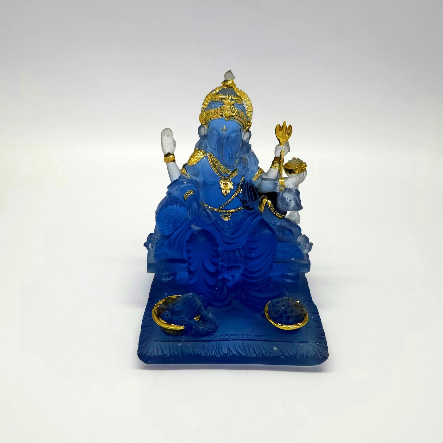 High-angle front view of a 13cm translucent frosted blue glass-look resin Ganesha statue showing the wide rectangular base