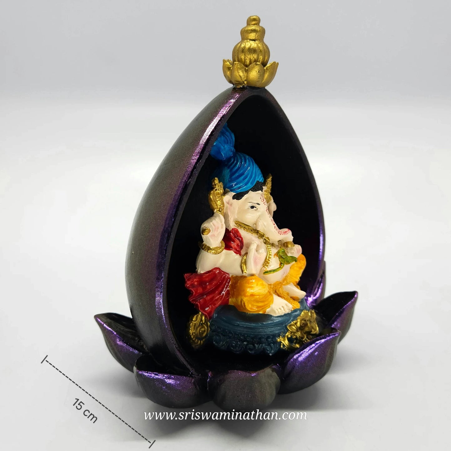 Three-quarter perspective of the assembled multi-color resin Ganesha idol showcasing the depth of the petal-shaped purple base