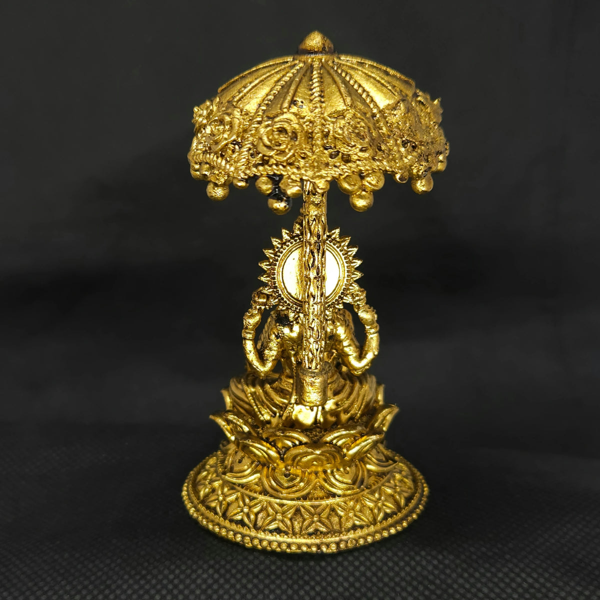 Direct straight back view of the two and a half inch solid brass Lakshmi statue with a Kudai canopy demonstrating the detailed rear surface of the umbrella dome and back hair curls