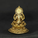 Direct straight back view of the solid brass Aishwarya Lakshmi statue demonstrating the detailed rear surface of the circular sunburst halo aura and smooth back base curves.