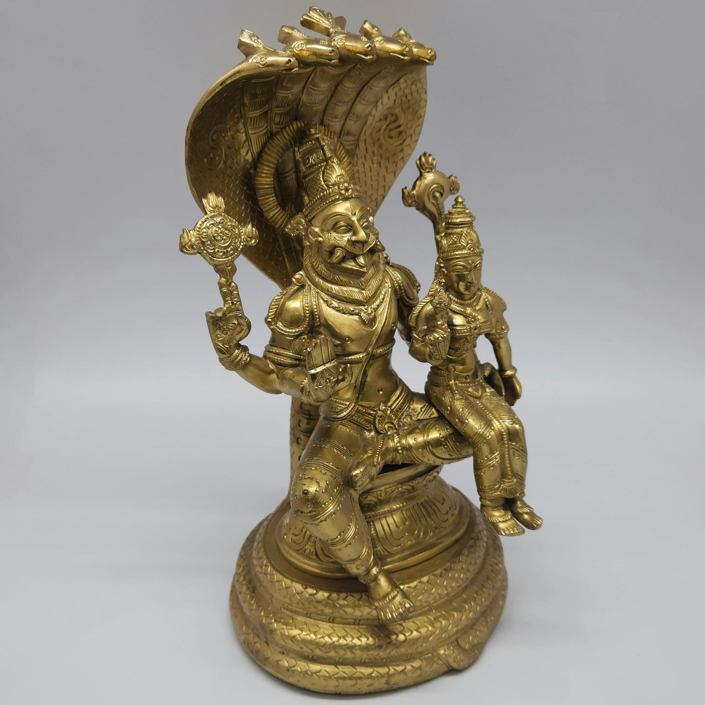 Right perspective view of the 8.2 kg solid brass Lakshmi Narasimha Swamy statue highlighting the detailed features of Goddess Lakshmi sitting on his lap.