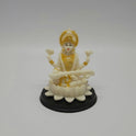 Front view of a 10.5cm white marble-finish resin Goddess Saraswati statue playing a veena on a circular black base by Sri Swaminathan and Co.