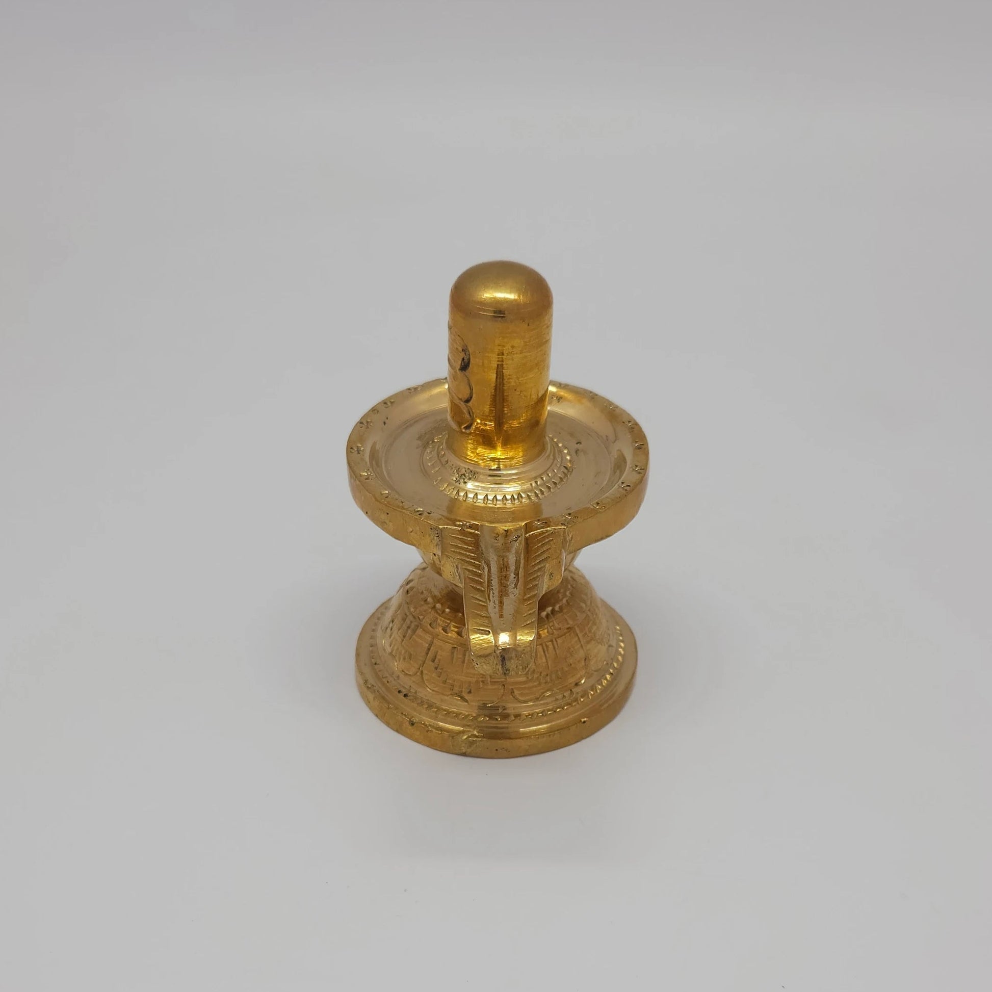 Sri Swaminathan and Co pure brass Shiva Lingam statue 8.5cm height 90-degree corner view focusing on the engraved padma peedam lotus base lines and spout 