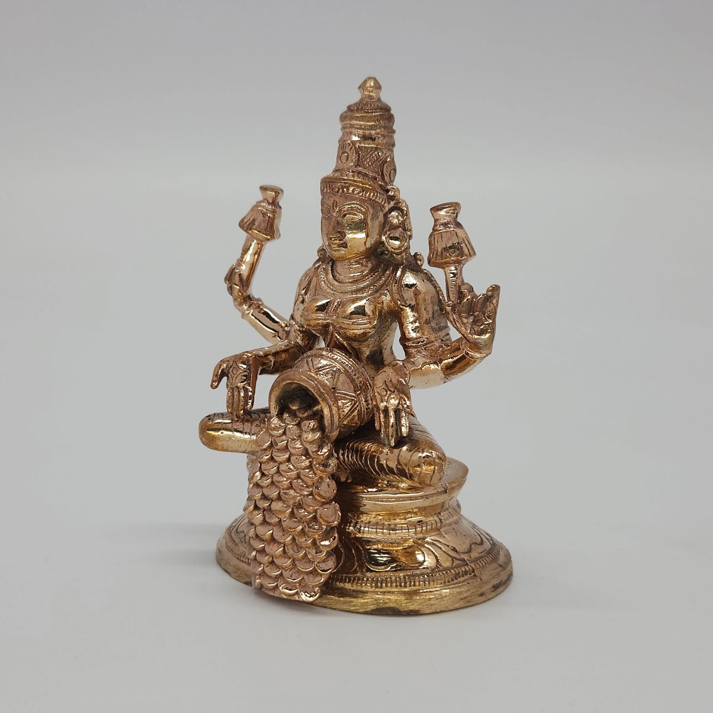 Sri Swaminathan and Co handcraft style Panchaloha Mahalakshmi Kubera Lakshmi statue 8.5cm height 45 degree right pose corner view focusing on the cascading gold coins and base depth