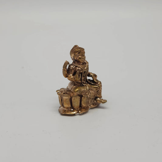 Sri Swaminathan and Co handcraft style Panchaloha miniature Balambigai statue 3.5cm height 45 degree right pose corner view focusing on varada mudra hand and lotus base depth