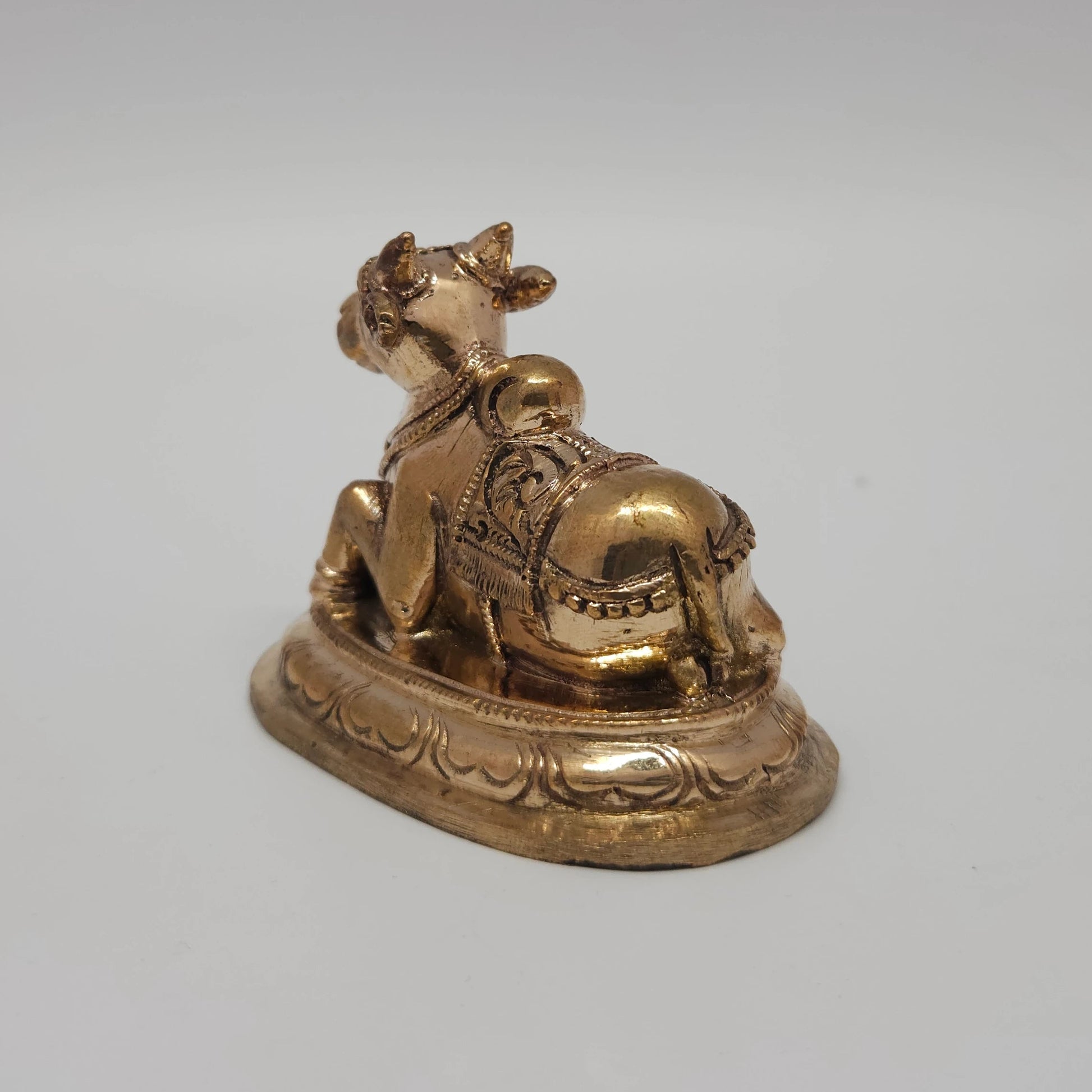 Sri Swaminathan and Co handcraft style Panchaloha Nandi statue 7.5cm length 45 degree right pose corner view focusing on oval lotus peedam base depth