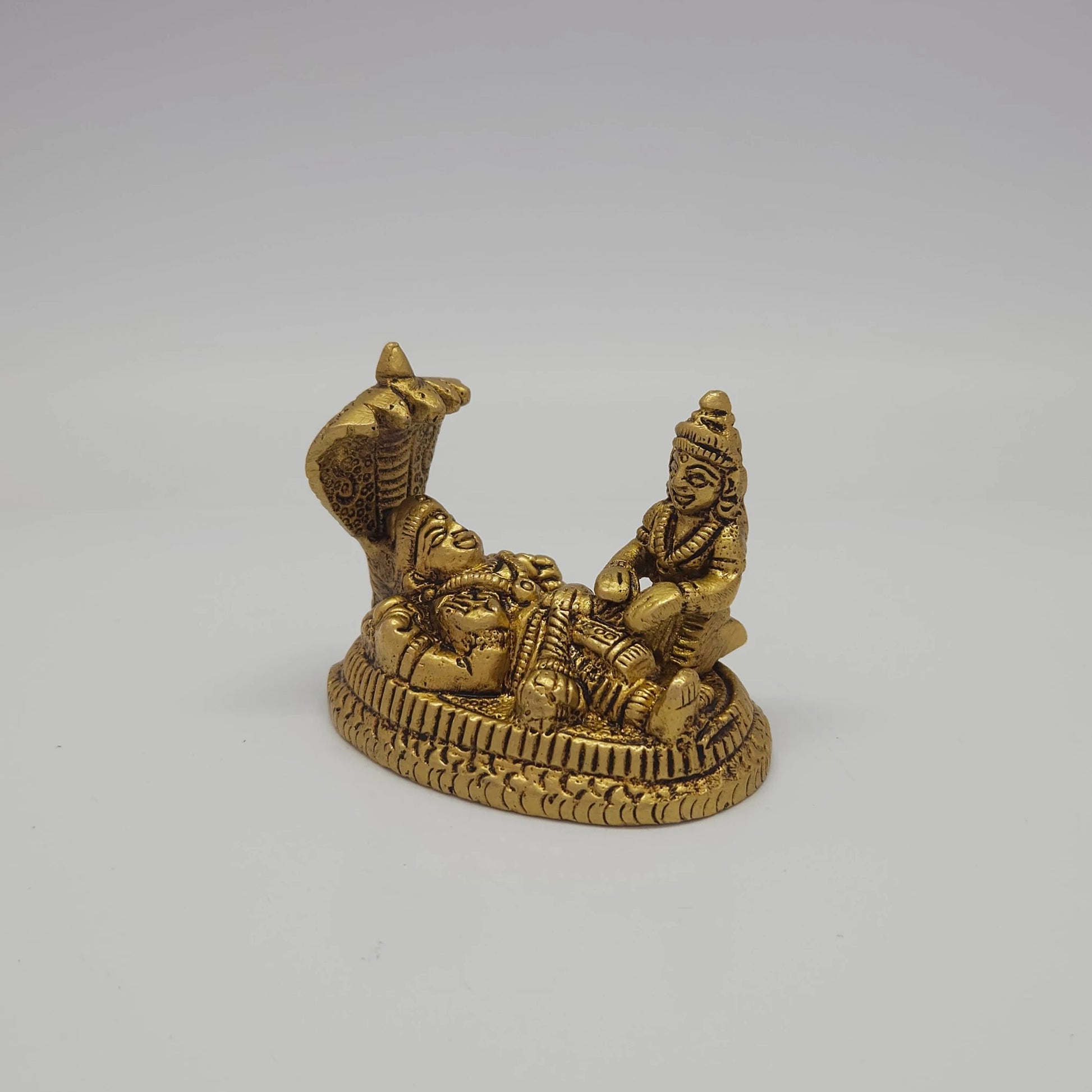 Sri Swaminathan and Co brass Ranganatha perumal statue antique finish 200g weight 45 degree right pose corner view focusing on Goddess Mahalakshmi seated near the feet profile and base depth