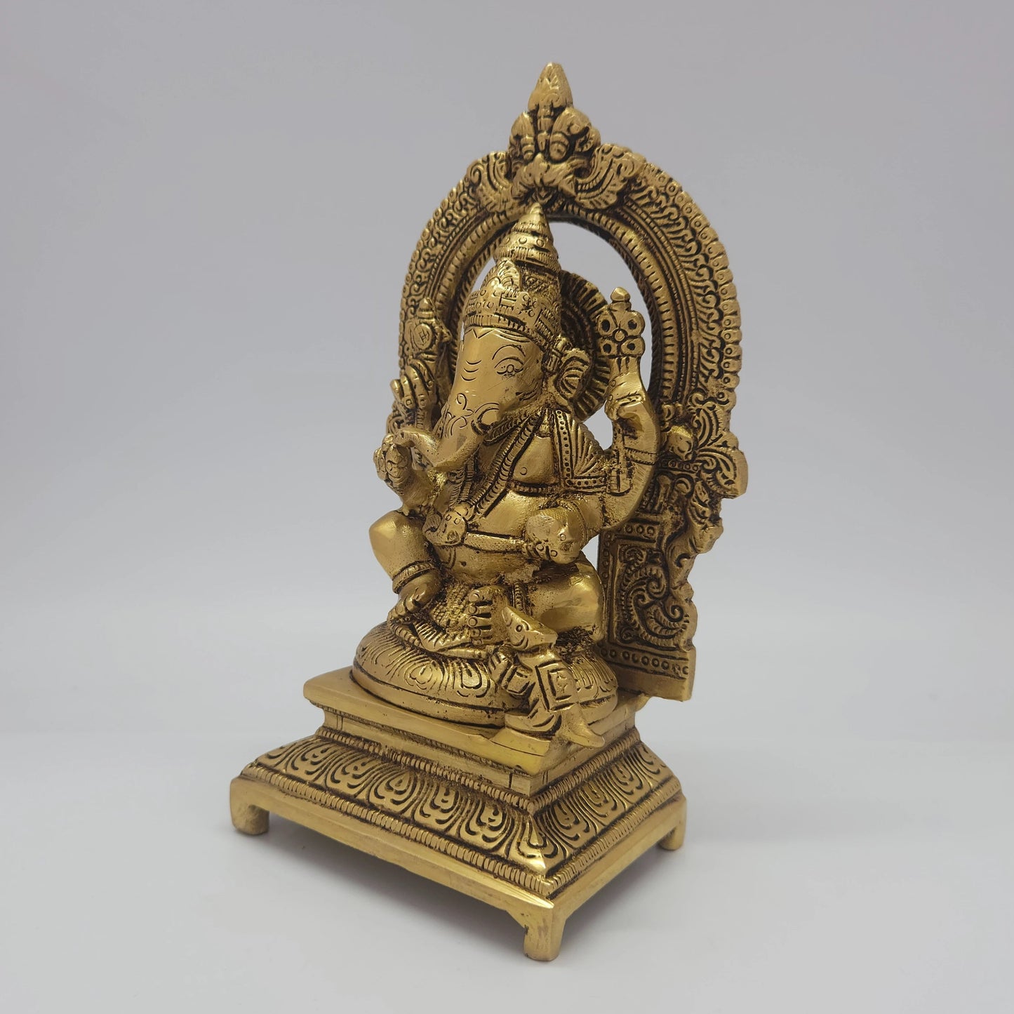 Sri Swaminathan and Co brass Gajanana Vinayaka statue antique finish 1.450kg weight 45 degree left pose corner view highlighting chiseled pasha noose attribute and ear profiles