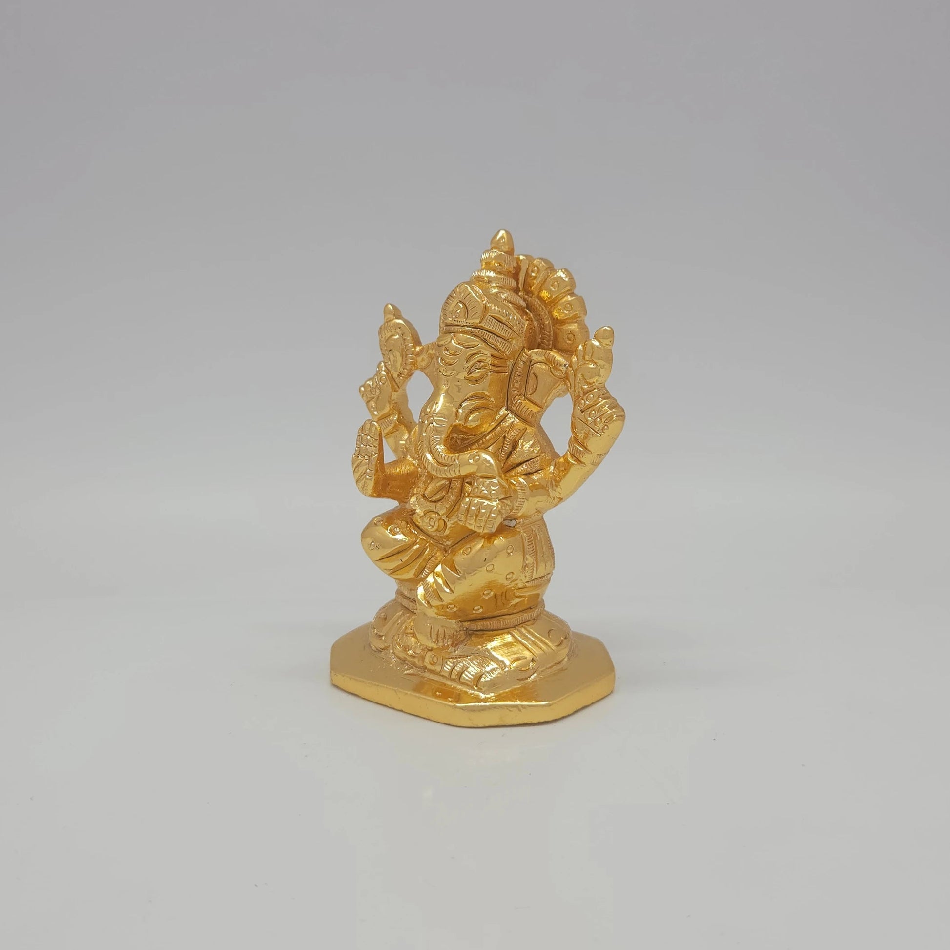 Sri Swaminathan and Co brass miniature Chaturbuja Ganapathi statue gold finish 300g weight 45 degree left pose corner view highlighting the pasha noose attribute and left ear profile