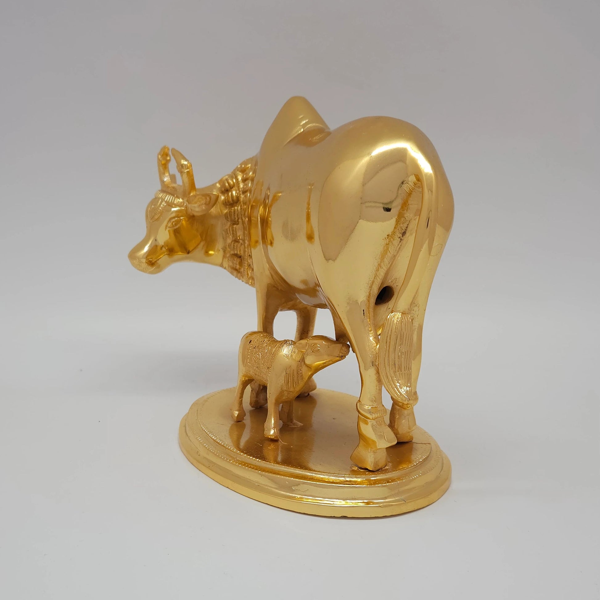 Sri Swaminathan and Co pure brass heavy Kamadhenu cow statue 2.25kg side posture view facing left side showing uniform satin gold finish layer from back side of Kamadhenu
