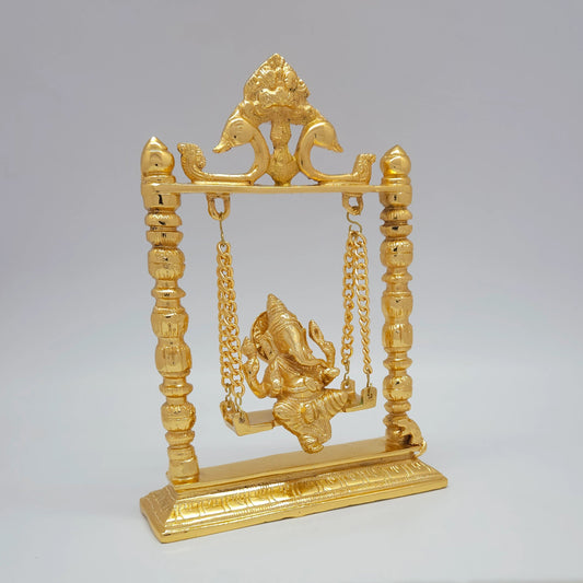 Sri Swaminathan and Co brass Jhula Ganesha swing statue gold finish 25cm height 45 degree right pose corner view focusing on the elephant head crown profile and base platform depth