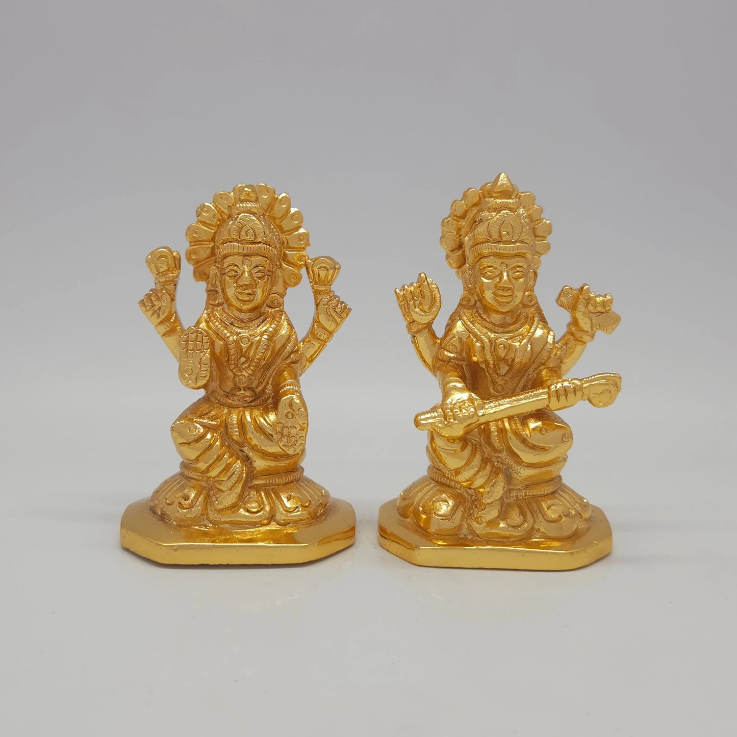 Sri Swaminathan and Co brass miniature Kalaimagal Saraswathi statue gold finish 300g weight 45 degree right pose corner view focusing on veena neck alignment and octagonal base depth of Goddess Saraswathi and Goddess Lakshmi
