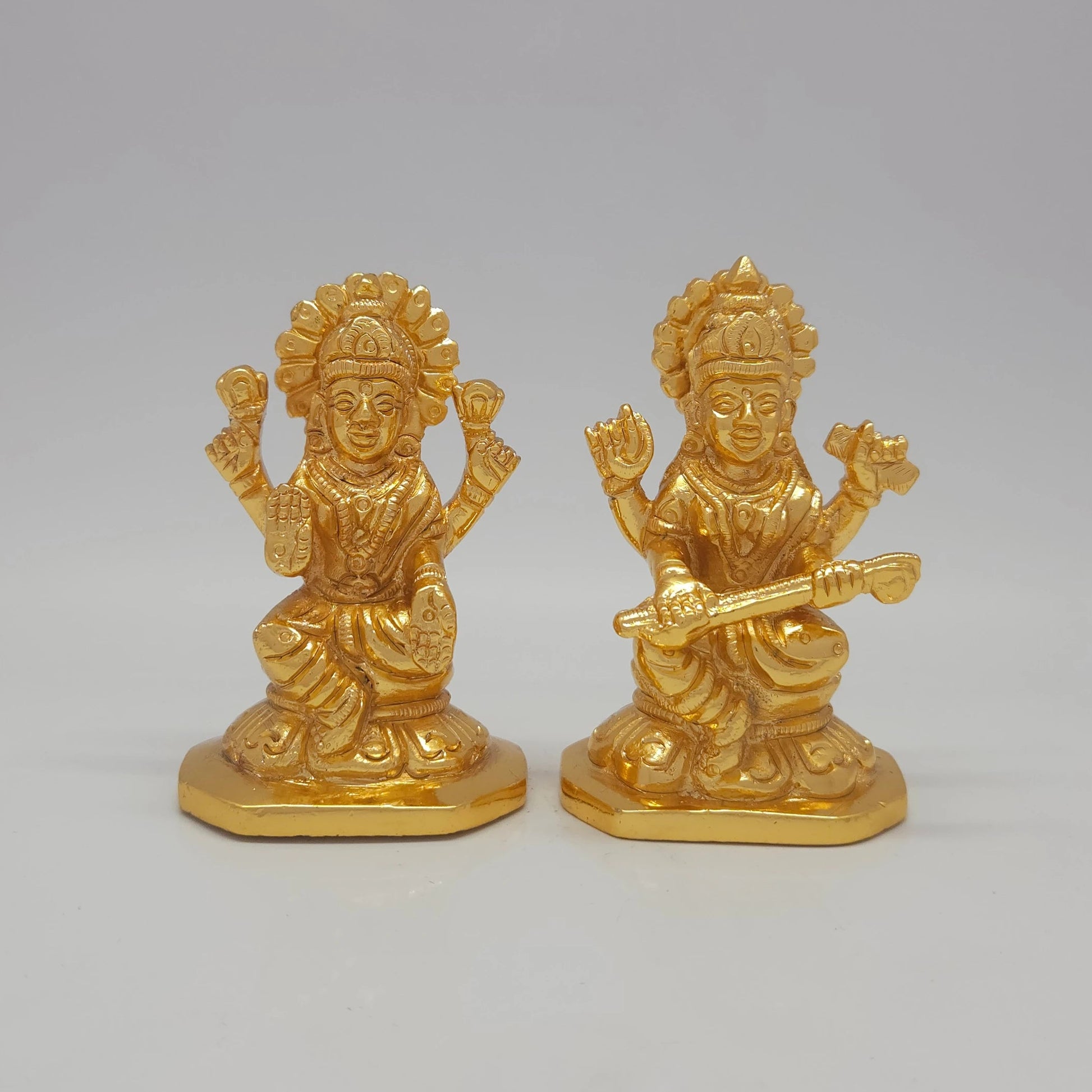 Sri Swaminathan and Co brass miniature Kalaimagal Saraswathi statue gold finish 300g weight 45 degree right pose corner view focusing on veena neck alignment and octagonal base depth of Goddess Saraswathi and Goddess Lakshmi