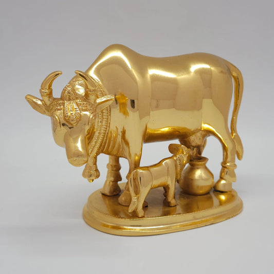 Sri Swaminathan and Co pure brass Kamadhenu cow and calf statue gold powder coated 16cm height 45 degree left pose corner view highlighting the chiseled neck bell collar detail