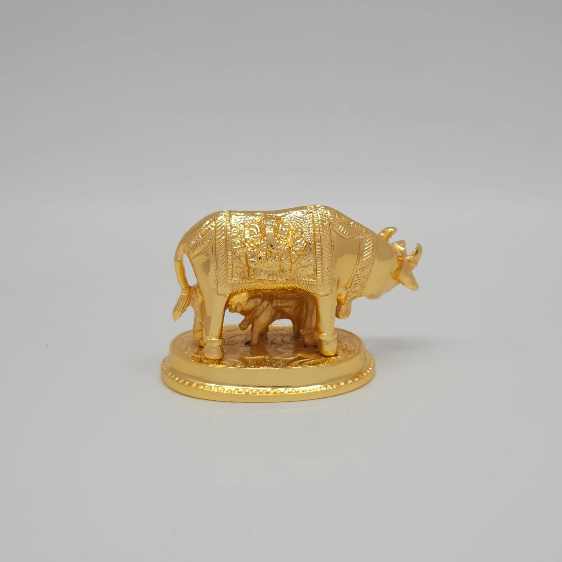 Sri Swaminathan and Co pure brass Kamadhenu cow and calf statue gold powder coated 7cm height back pose full rear view showing reverse of tail and embossed side blanket