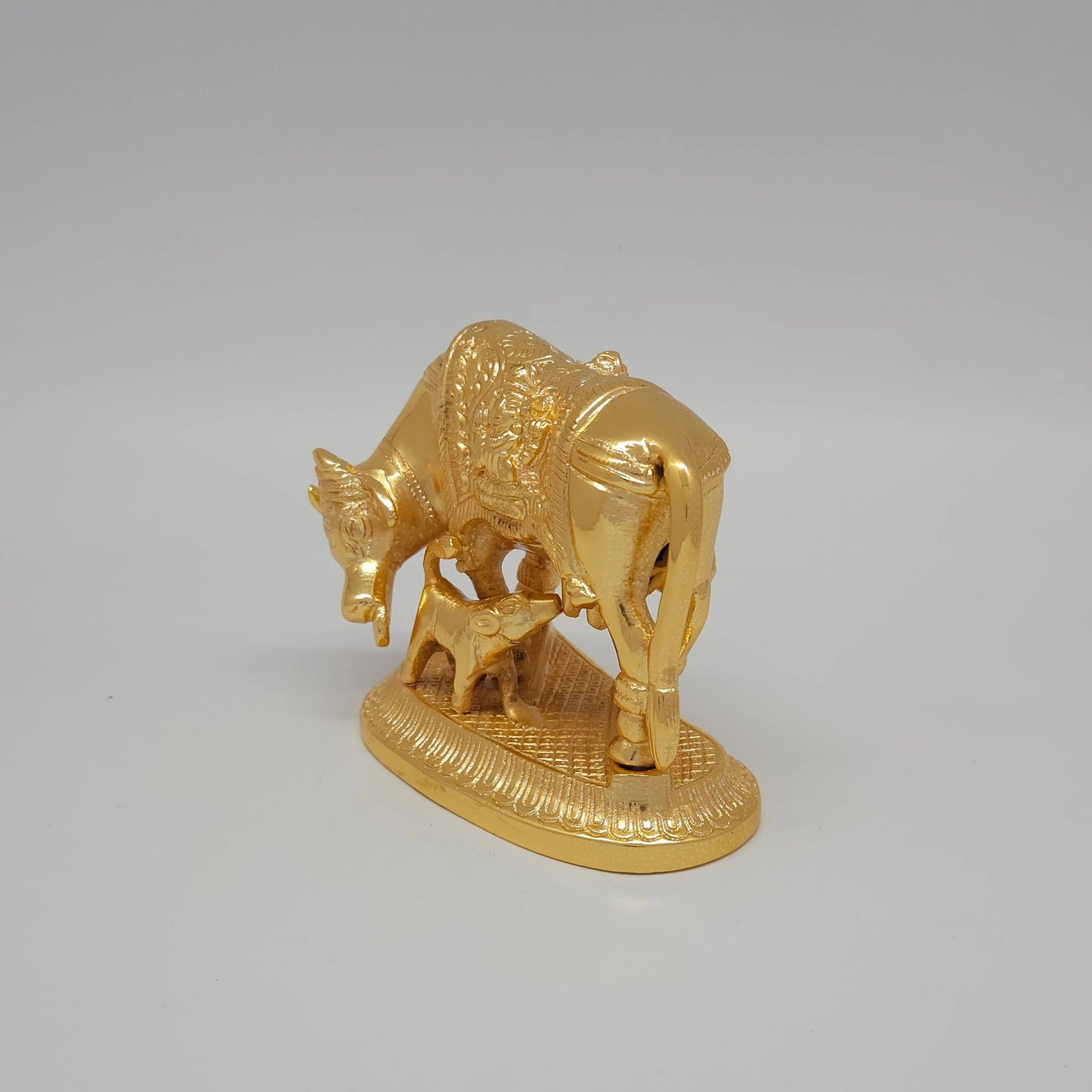 Sri Swaminathan and Co pure brass Kamadhenu cow and calf statue gold powder coated 9cm height side posture view facing left side tracking the total 12cm length measurements