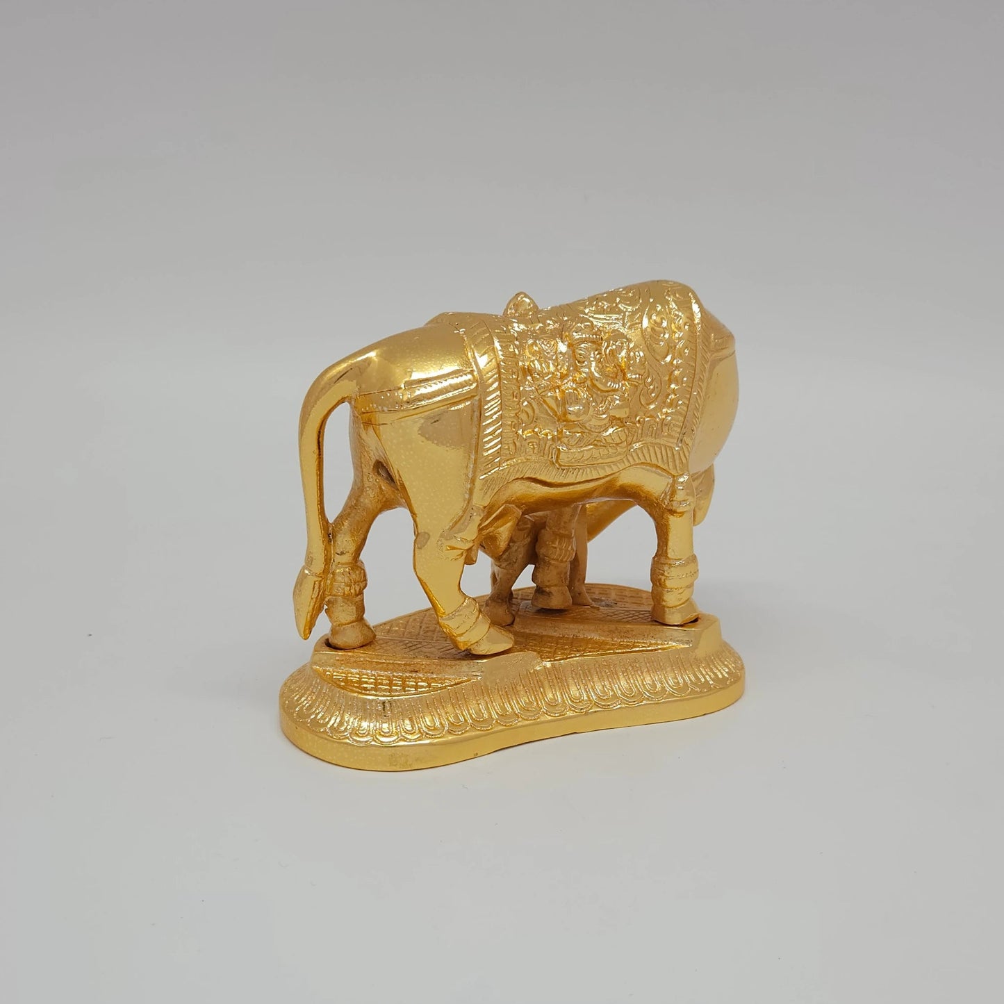 Sri Swaminathan and Co pure brass Kamadhenu cow and calf statue gold powder coated 9cm height side posture view facing right side showing uniform satin gold finish layer