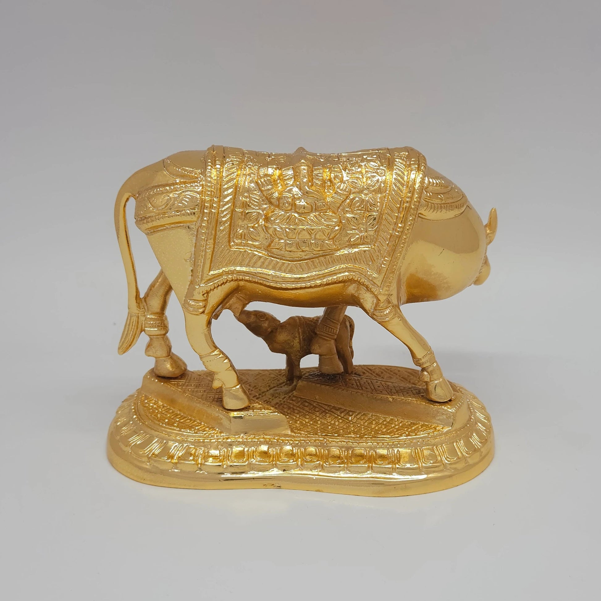 Sri Swaminathan and Co pure brass Kamadhenu cow and calf statue 2kg weight back pose full rear view showing reverse of polished tail and layered lotus petal pedestal base
