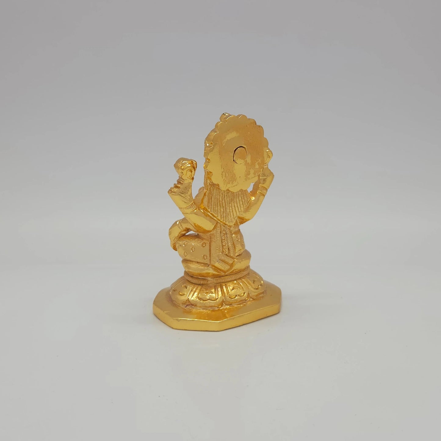 Sri Swaminathan and Co brass miniature Mahalakshmi statue gold finish 275g weight back pose 45-degree rear view showing reverse of radiating crown halo and octagonal base platform