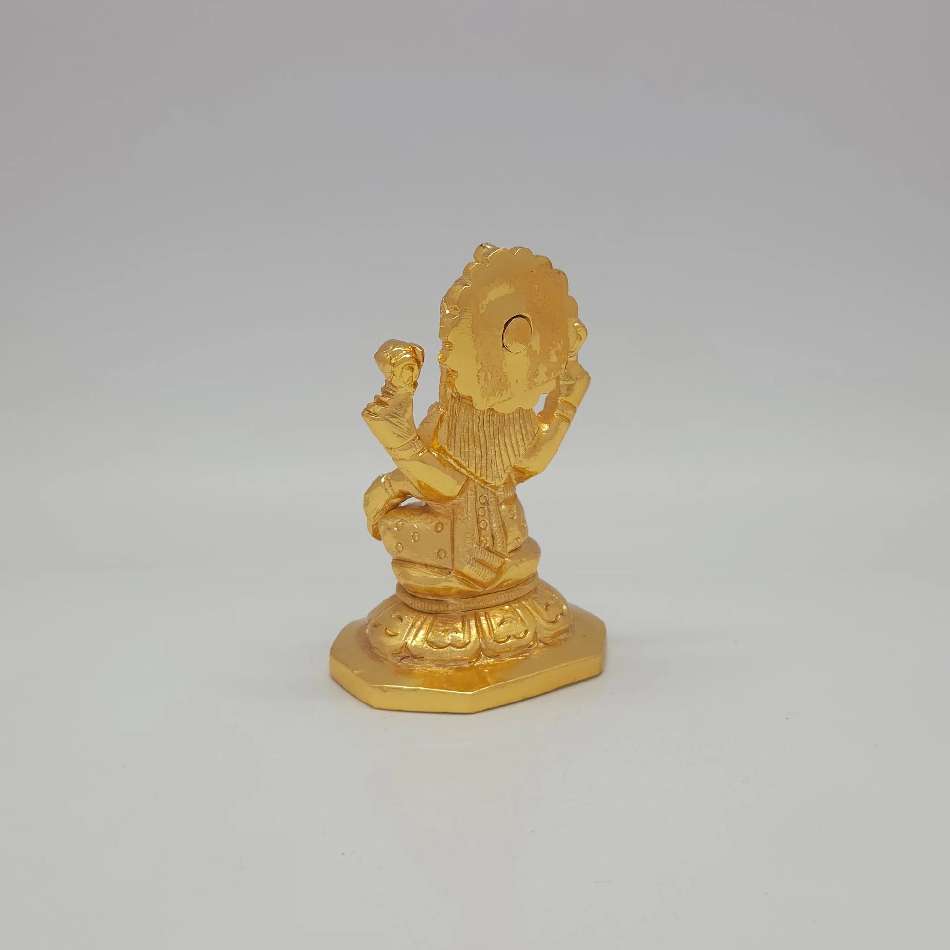 Sri Swaminathan and Co brass miniature Mahalakshmi statue gold finish 275g weight back pose 45-degree rear view showing reverse of radiating crown halo and octagonal base platform