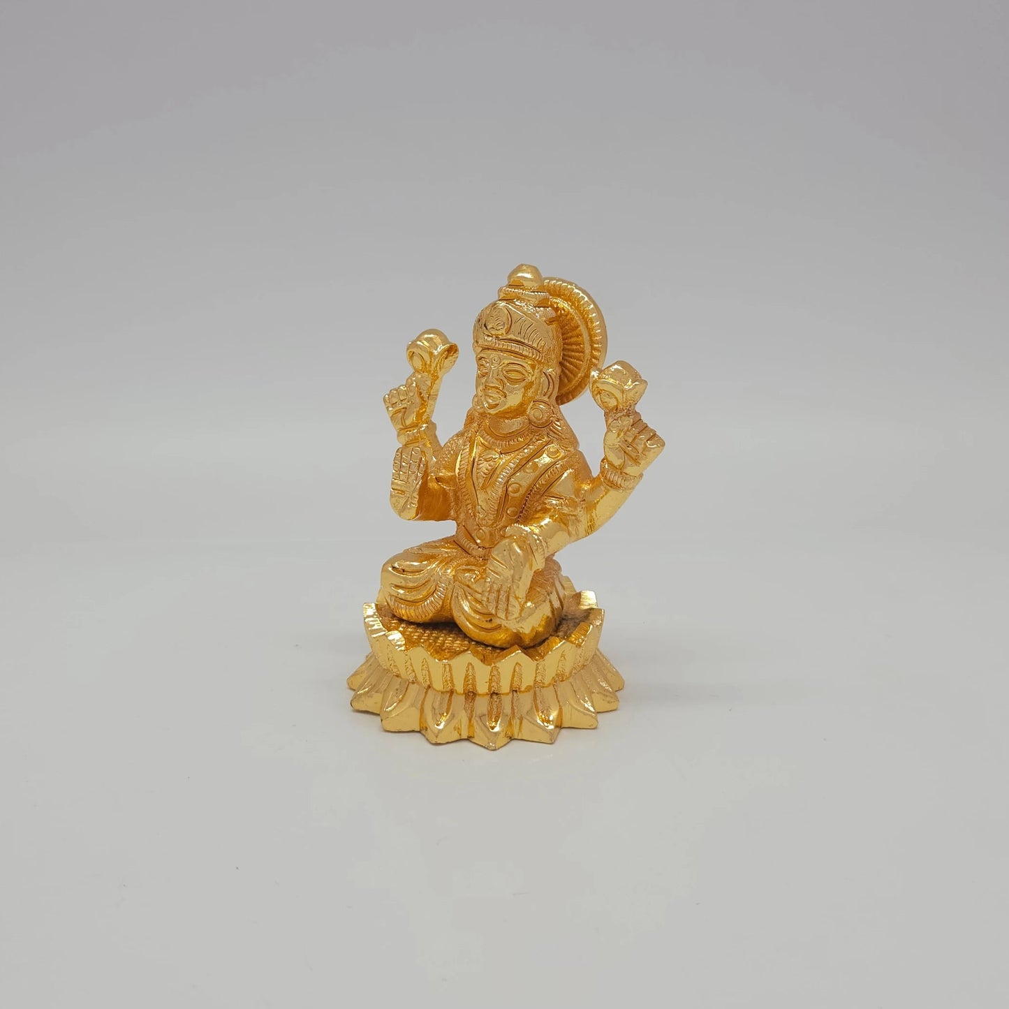 Sri Swaminathan and Co brass miniature Mahalakshmi statue gold finish 200g weight 45 degree left pose corner view highlighting the upper left lotus bud and round base depth
