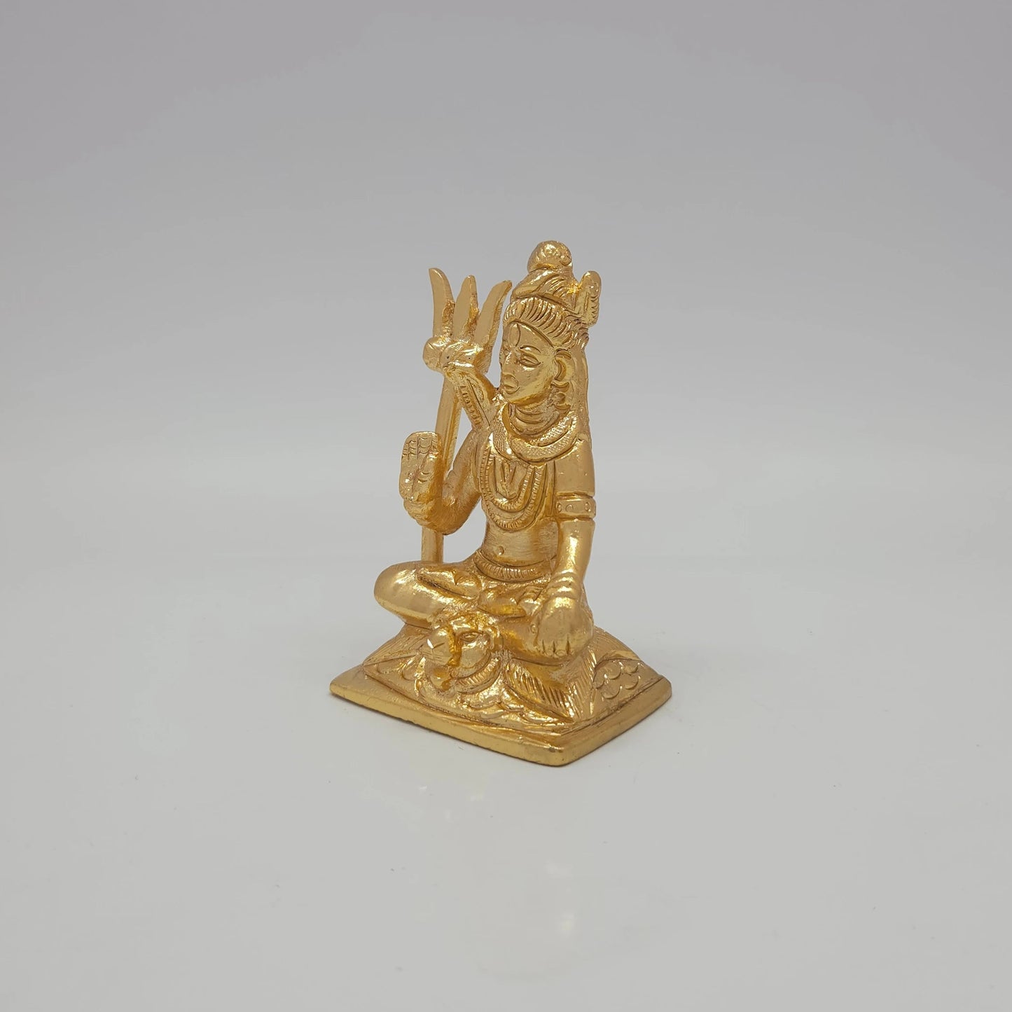 Sri Swaminathan and Co brass meditation Shiva statue gold finish 170g weight 45 degree left pose corner view highlighting the freestanding trishula trident attribute lines