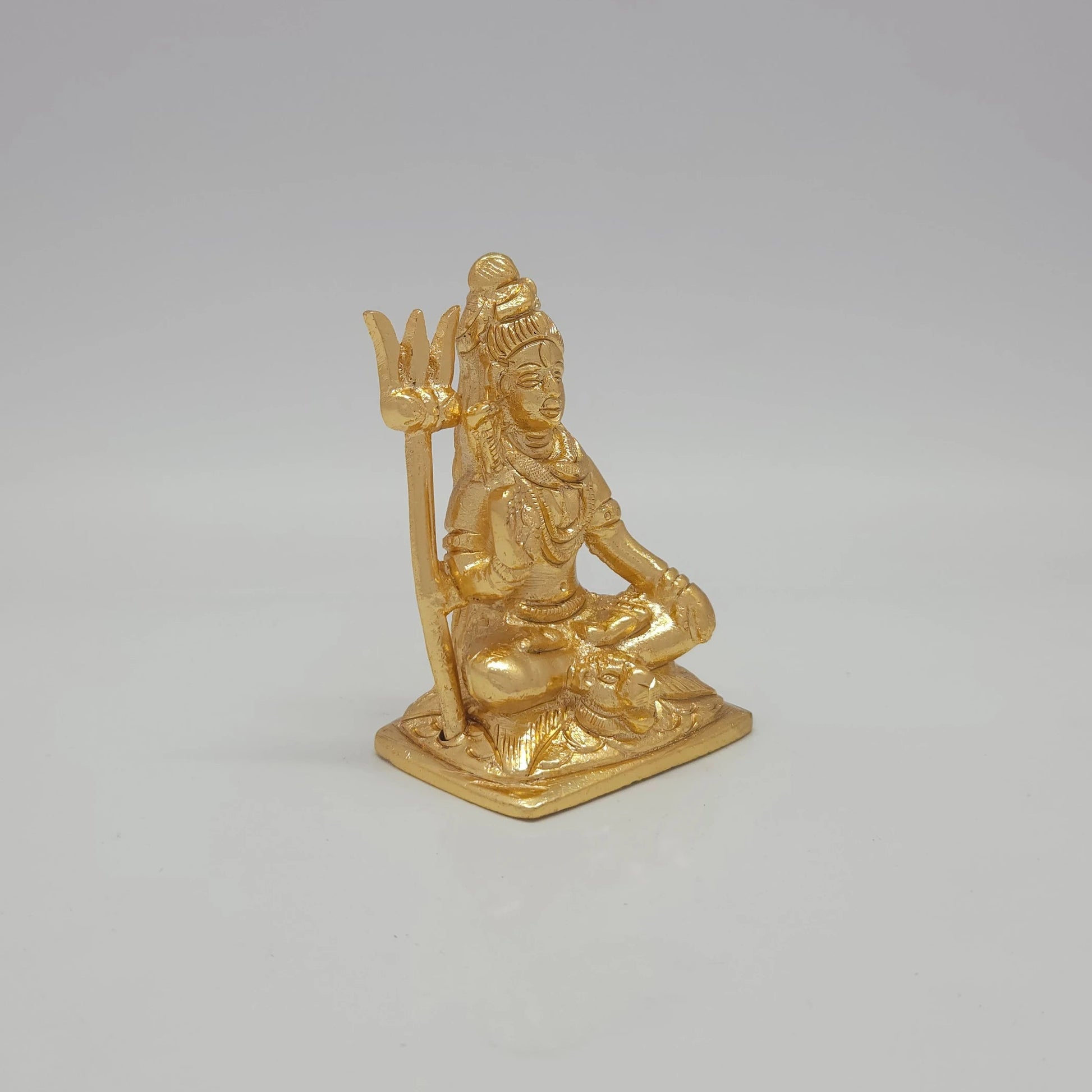 Sri Swaminathan and Co brass meditation Shiva statue gold finish 170g weight 45 degree right pose corner view focusing on protective abhaya mudra hand and base platform depth