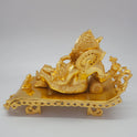 Sri Swaminathan and Co brass reclining Ganesha statue gold powder coated 11 inch 27cm length back pose full rear view showing reverse of carved couch frame and headboard back