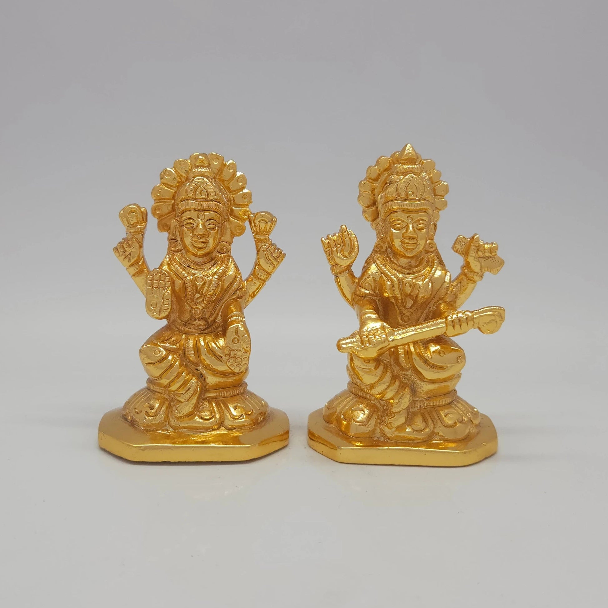 Sri Swaminathan and Co brass miniature Mahalakshmi statue gold finish 275g weight 45 degree right pose corner view focusing on protective abhaya mudra hand and octagonal base   Saraswathi with veena