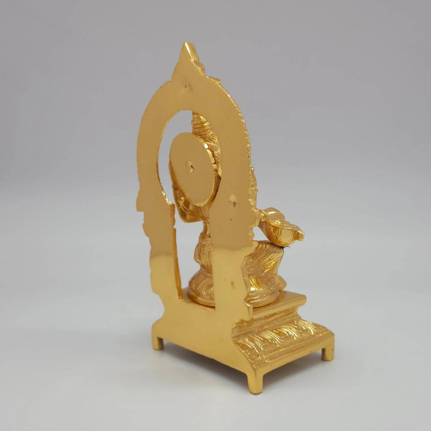 Sri Swaminathan and Co brass Sharada Saraswathi statue gold finish 1.37kg weight back pose 45-degree rear view showing reverse of circular thiruvatchi arch and square pedestal base
