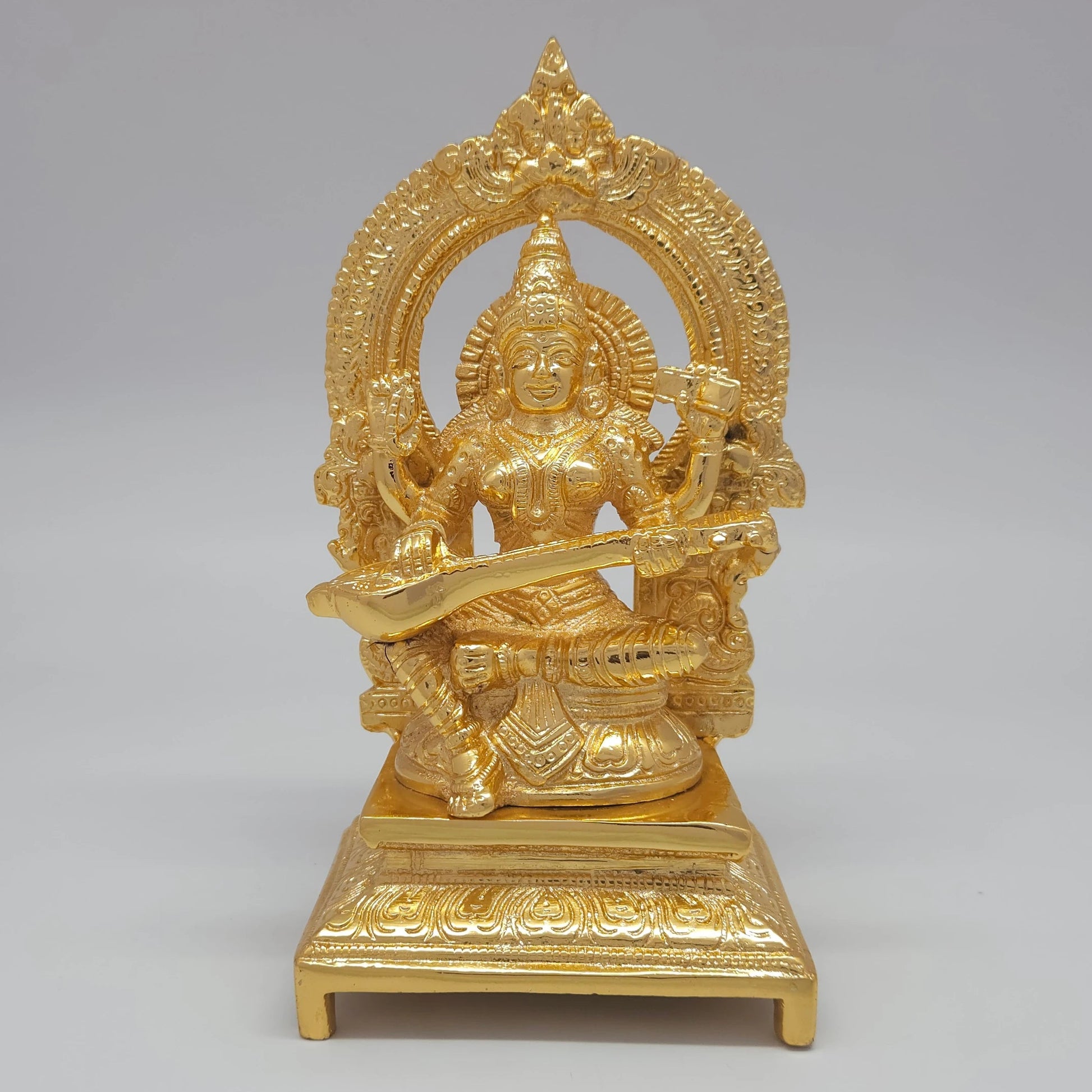 Sri Swaminathan and Co premium brass seated Goddess Sharada Saraswathi statue veena thiruvatchi arch gold powder coated finish for gifting and decor purpose