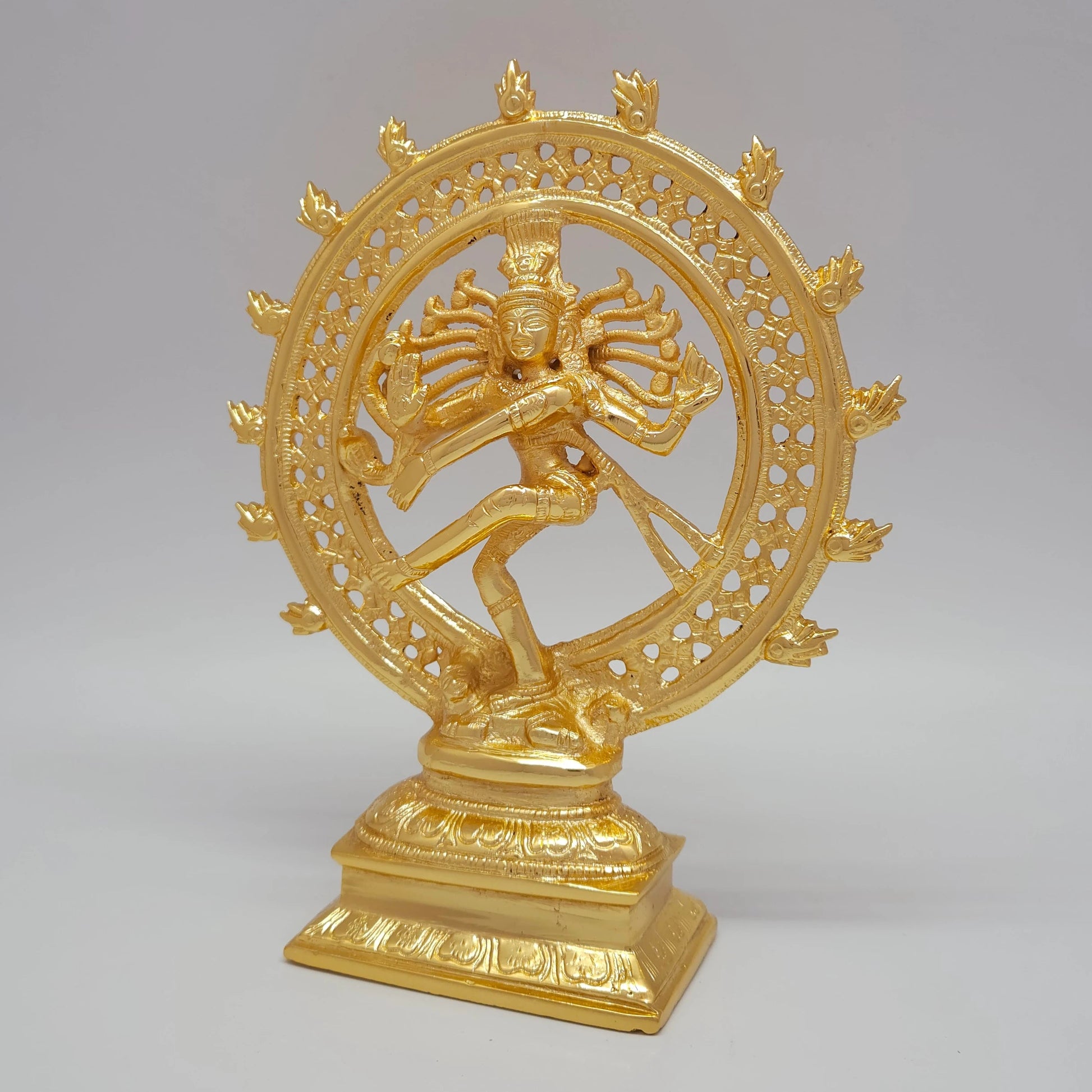 Sri Swaminathan and Co brass Shiva Tandava statue gold powder coated finish 23.5cm height 45 degree left pose corner view highlighting the damaru drum and abhaya mudra hand detail
