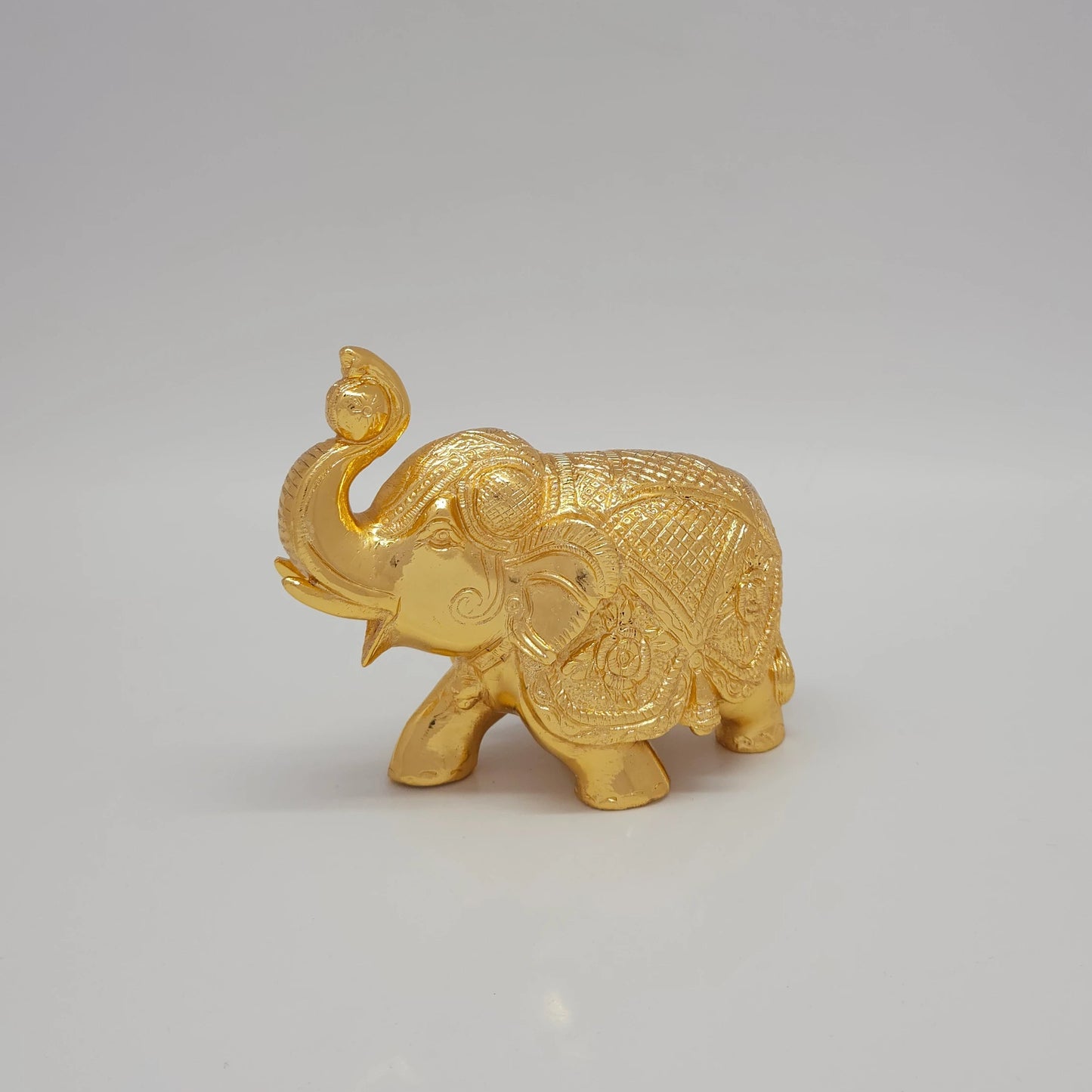 Sri Swaminathan and Co brass elephant statue gold powder coated 4 inch 11cm height side posture view facing left side tracking lateral length measurements