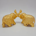 Sri Swaminathan and Co brass elephant statue gold powder coated 4-inch 11cm height posture mirror view facing each other 45-degree side showing uniform satin gold finish layer