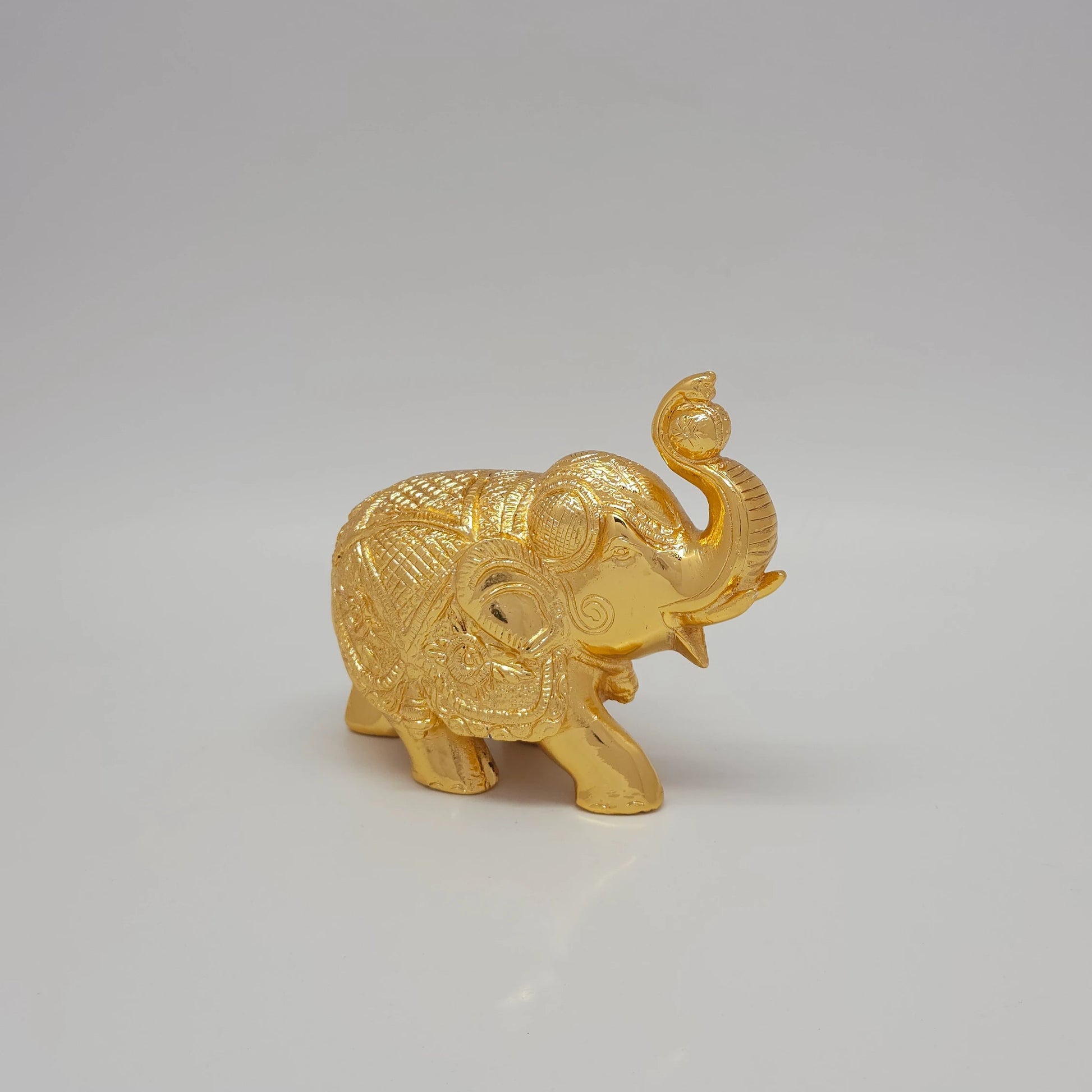 Sri Swaminathan and Co brass elephant statue gold powder coated 4 inch 11cm height side posture view facing right side showing uniform satin gold finish layer