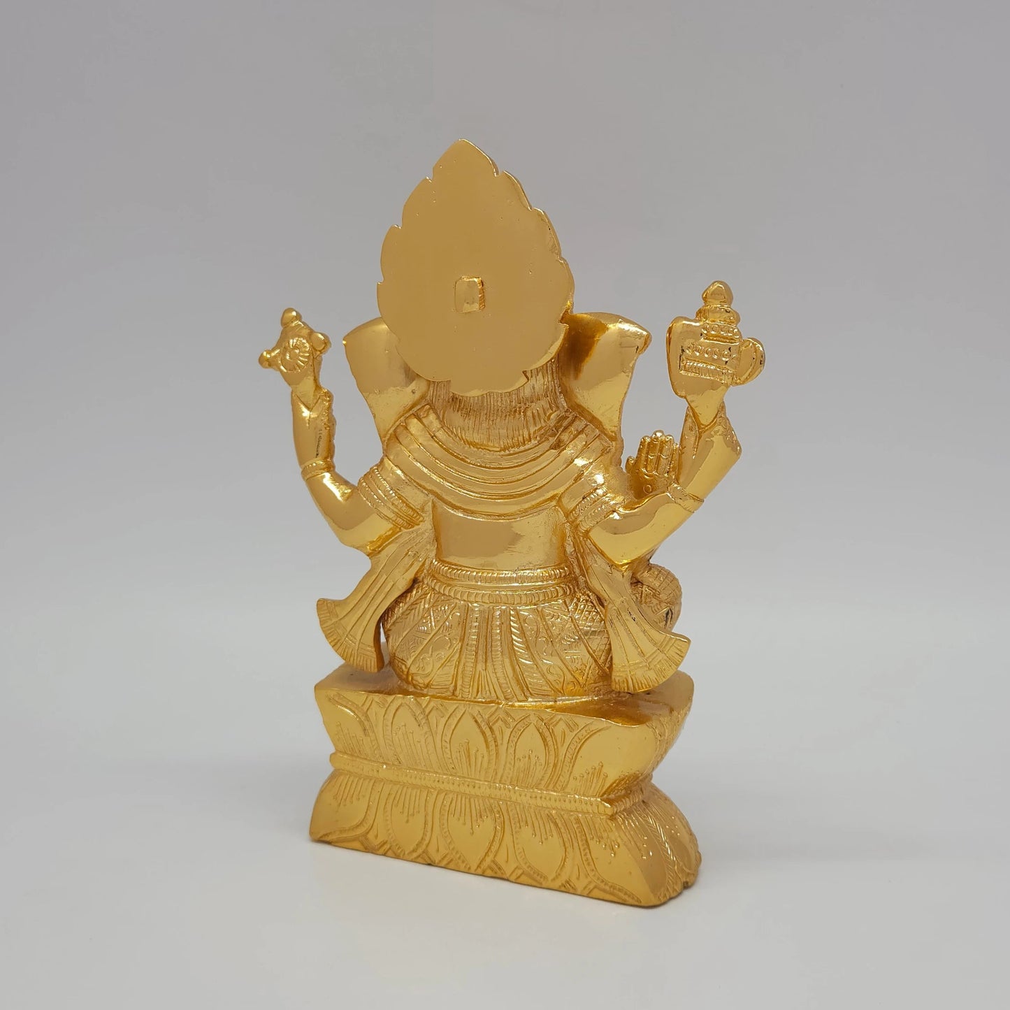 Sri Swaminathan and Co brass Vigneshwara statue gold finish 18.5cm height back pose full 45-degree rear view showing reverse of tiered crown and lotus pedestal base
