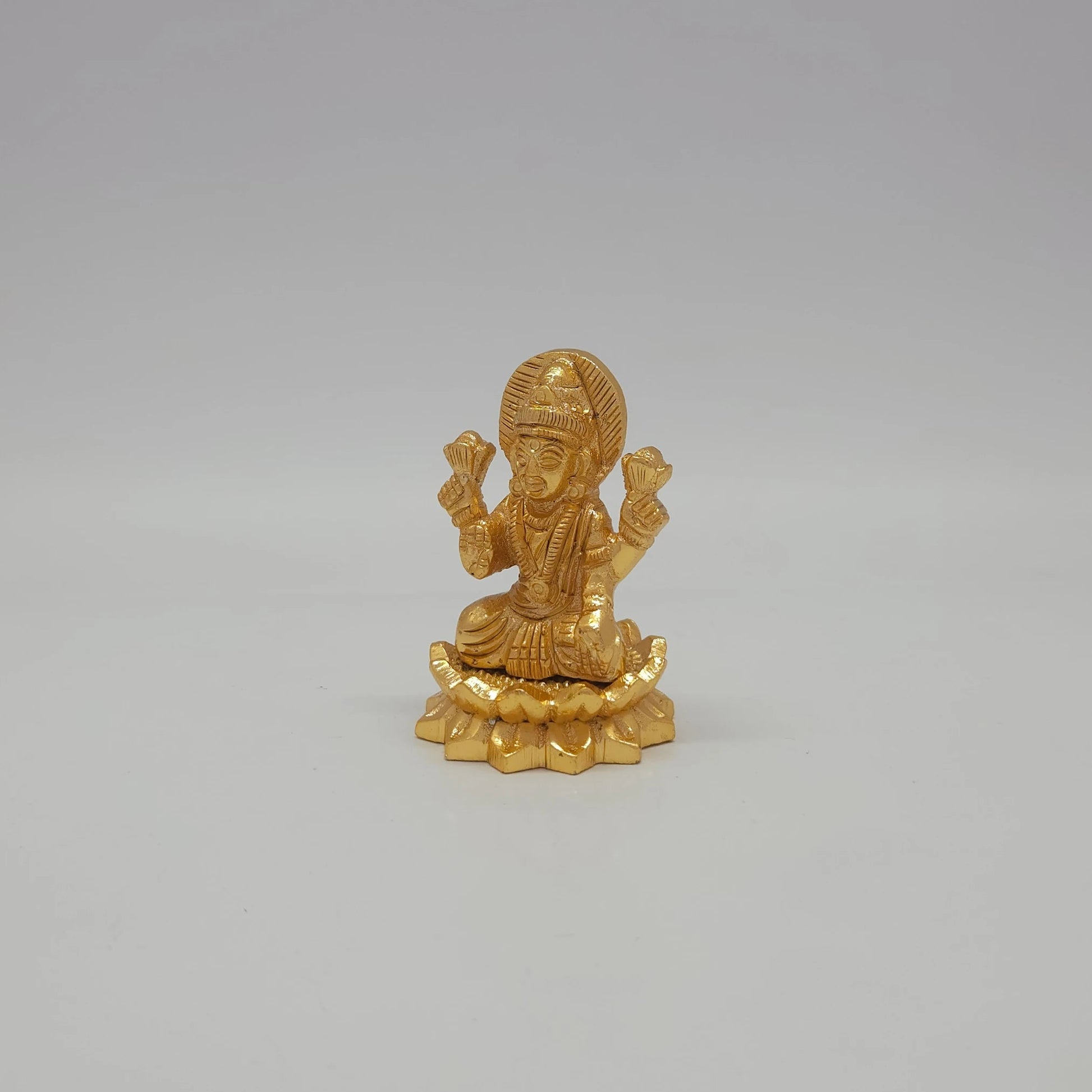 Sri Swaminathan and Co small gold finish Lakshmi statue 110g weight 45 degree left pose corner view highlighting the upper lotus buds and downward flaring petal trim profiles