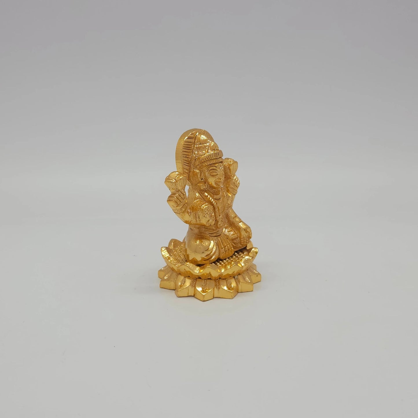 Sri Swaminathan and Co small gold finish Lakshmi statue 110g weight 45 degree right pose corner view tracking the raised right palm lines and 3.5cm base diameter limits