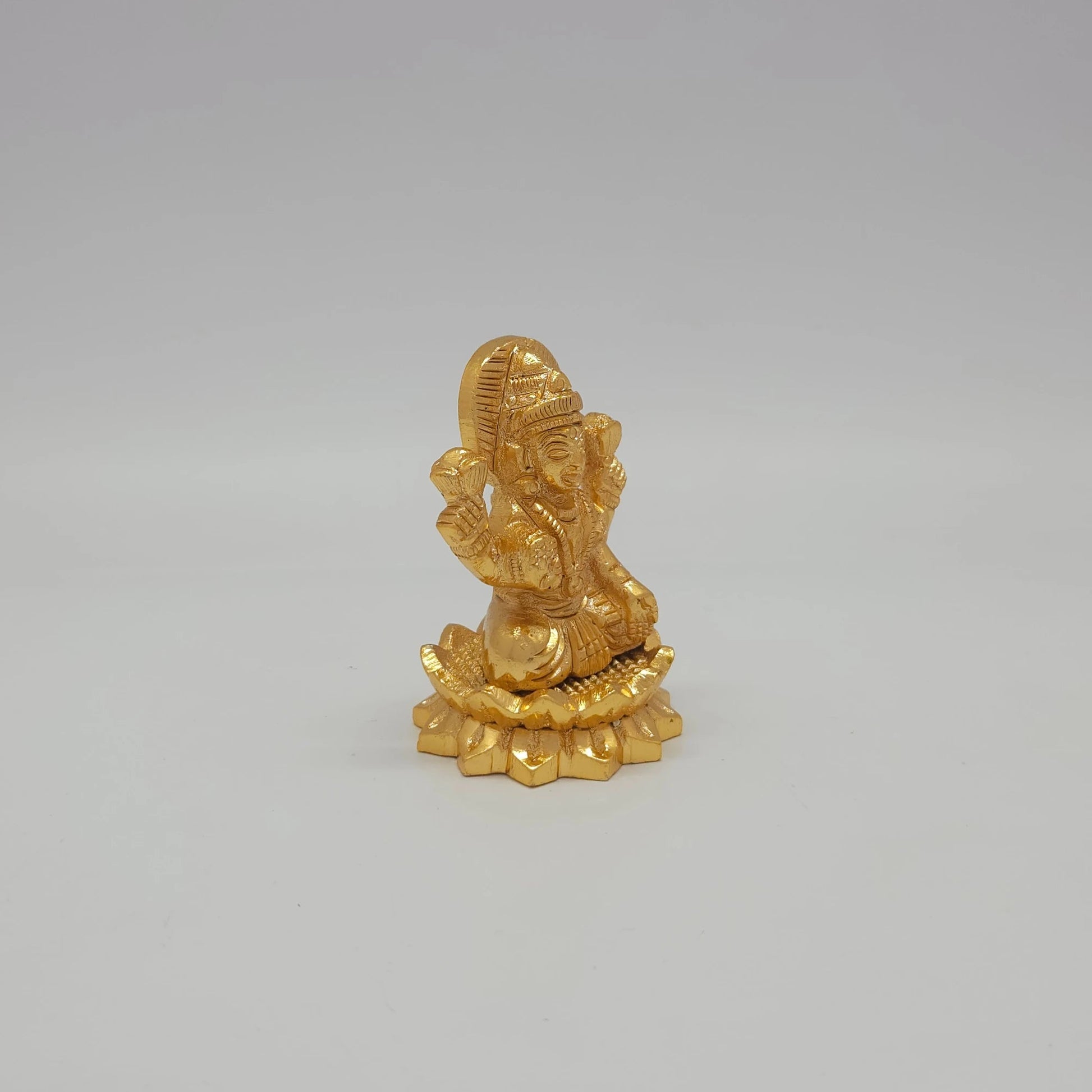 Sri Swaminathan and Co small gold finish Lakshmi statue 110g weight 45 degree right pose corner view tracking the raised right palm lines and 3.5cm base diameter limits