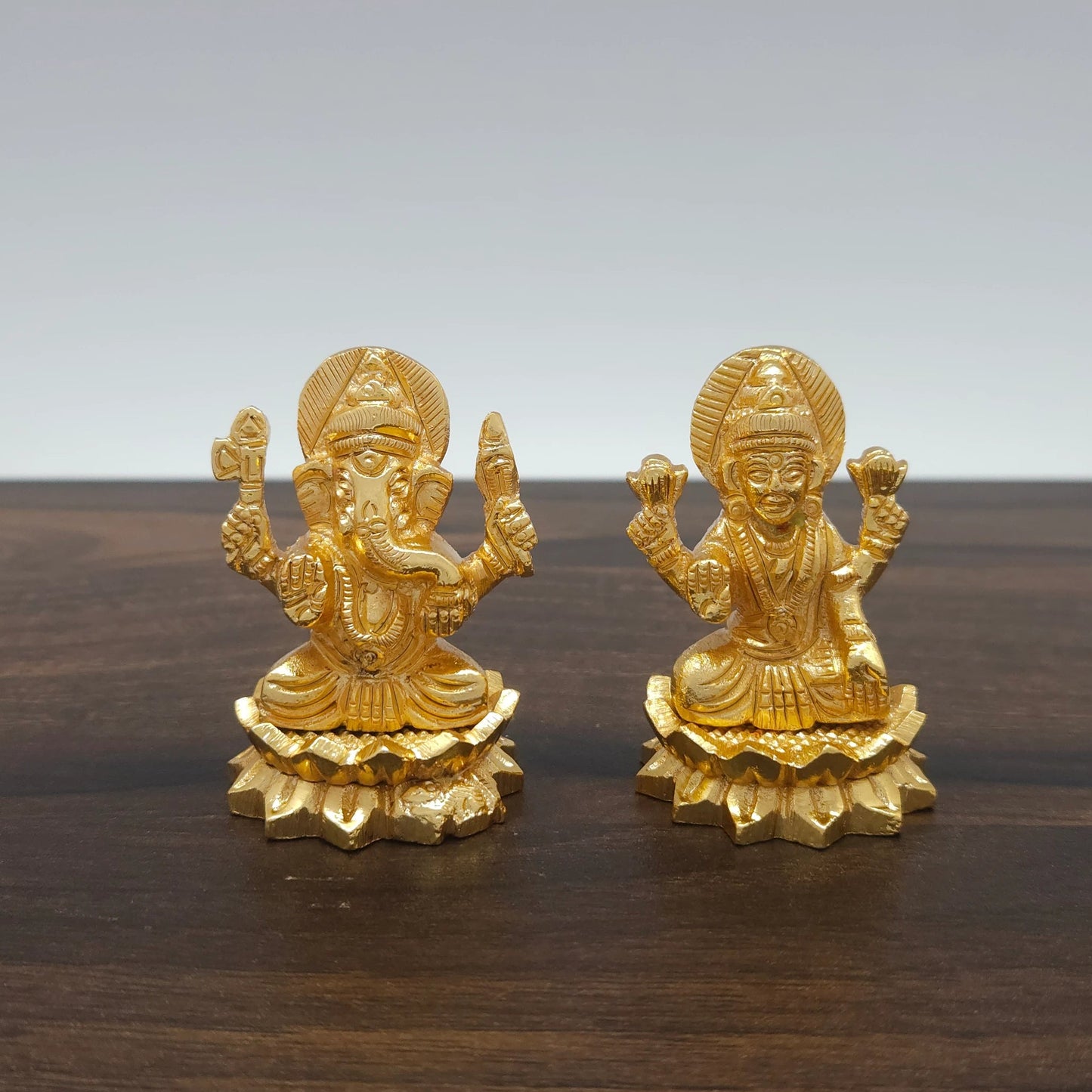 Sri Swaminathan and Co premium brass seated Ganapathi and Goddess Mahalakshmi statue twin lotus flared round base satin gold finish 110g weight front straight profile view