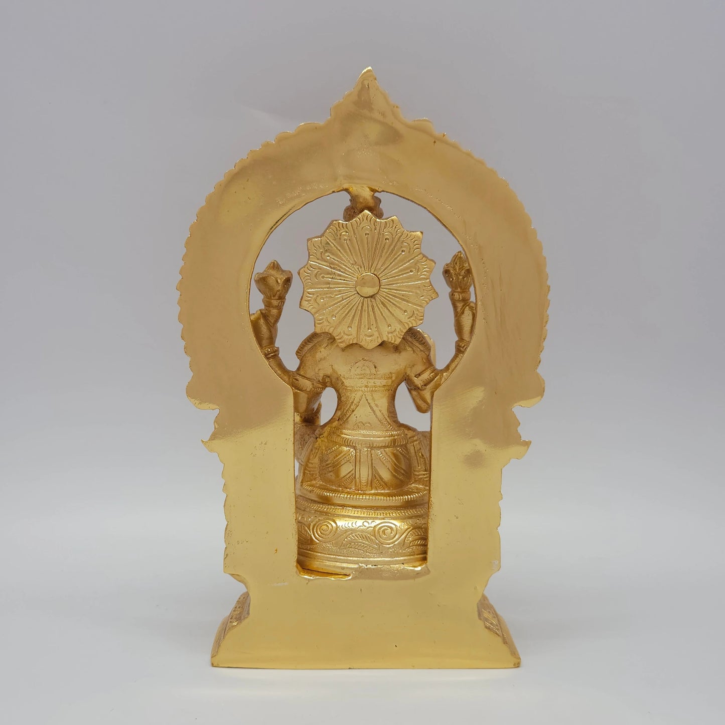 Sri Swaminathan and Co grand gold finish Lakshmi statue 3kg weight back pose rear angle view tracking the reverse side of the chiseled thiruvatchi temple archway frame and octagonal base