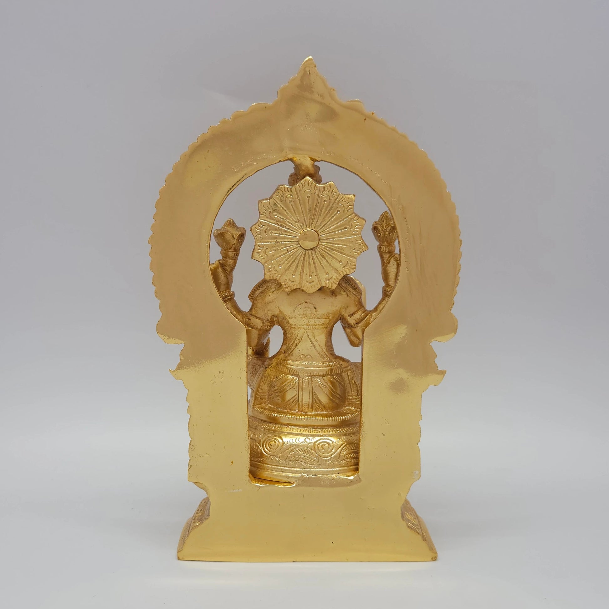 Sri Swaminathan and Co grand gold finish Lakshmi statue 3kg weight back pose rear angle view tracking the reverse side of the chiseled thiruvatchi temple archway frame and octagonal base
