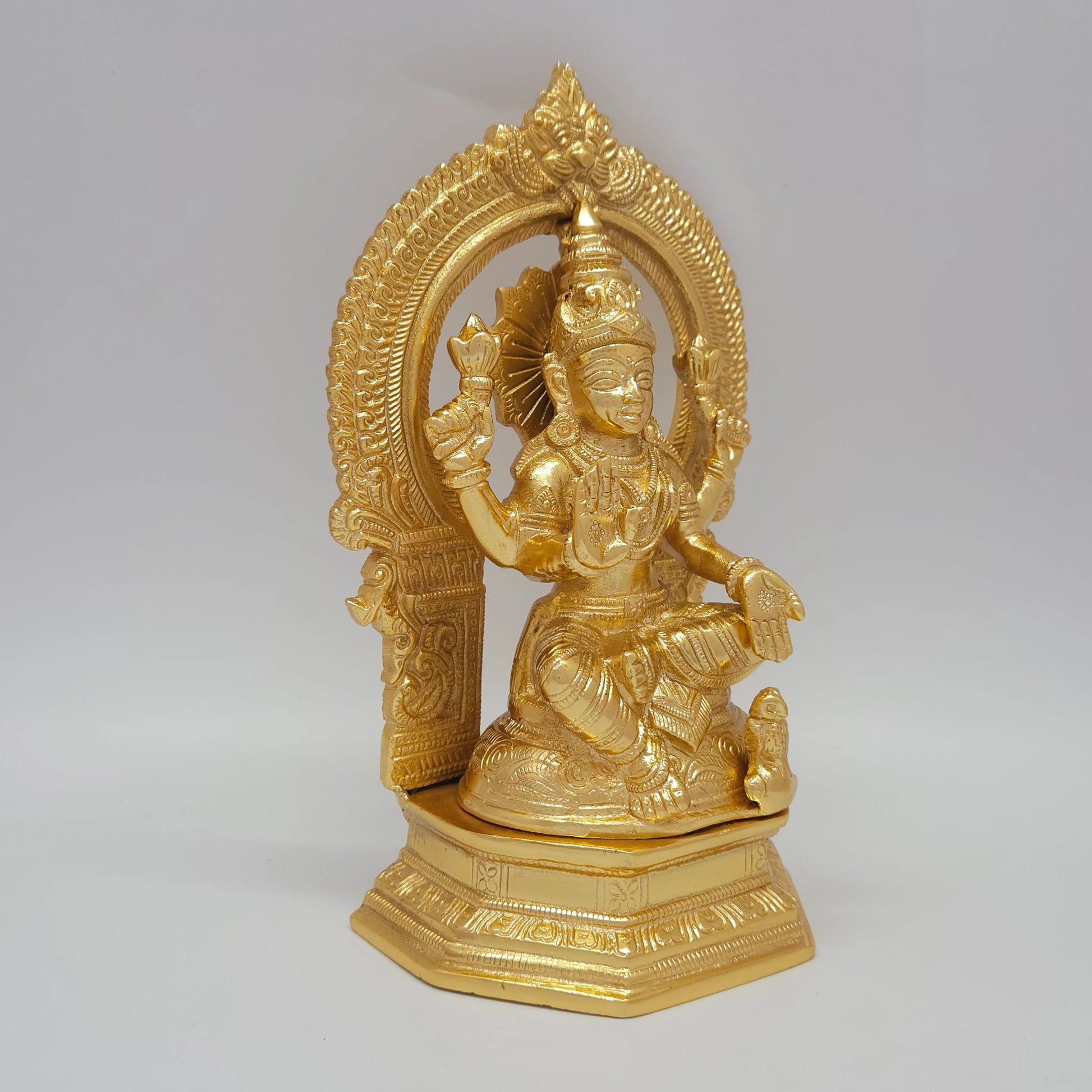 Sri Swaminathan and Co grand gold finish Padmasana Lakshmi statue 45 degree right pose corner view focusing on the protective abhaya mudra palm profile and octagonal pedestal base depth