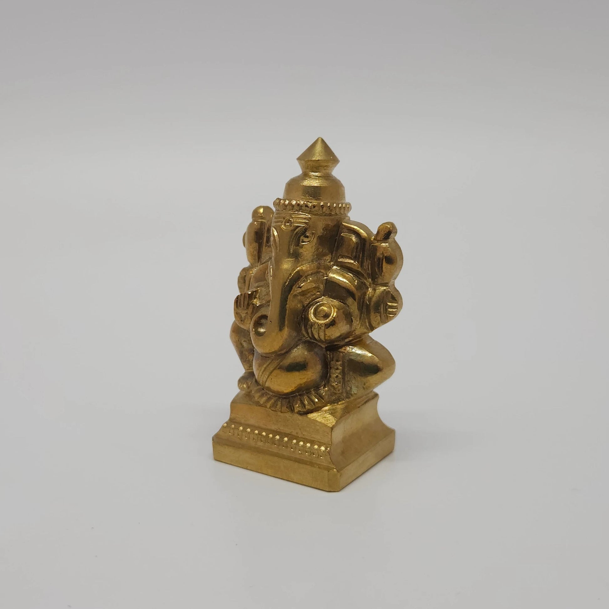 Sri Swaminathan and Co solid brass miniature Ganesha statue gold finish 45 degree right pose corner view focusing on side thickness and base depth