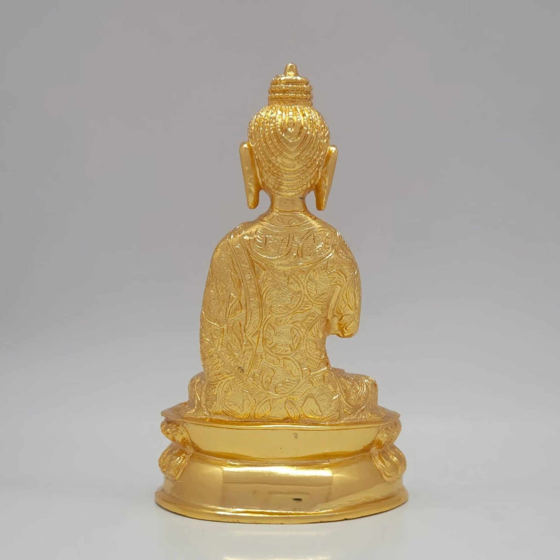 Rear view detailing the extensive scrollwork robe patterns and uniform gold sheen of the 1.35kg decorative sculpture.
