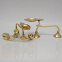 Three pure brass handheld aarti oil lamps shown from multiple angles to highlight the leaf-shaped oil cup and arched handle design.